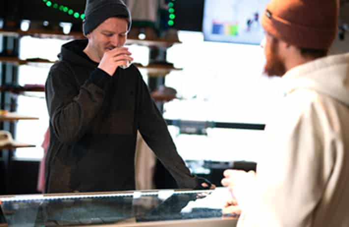 image of someone smelling cannabis in the Billo Dispensary, they are smiling and happy