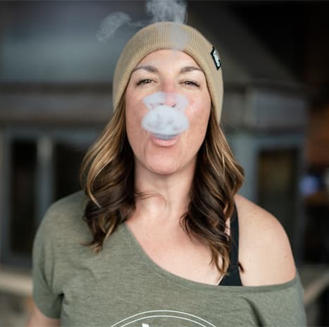 woman smoking weed and exhaling in steamboat springs colorad