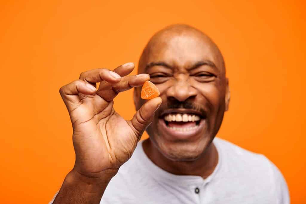 Smiling man with marijuana edibles